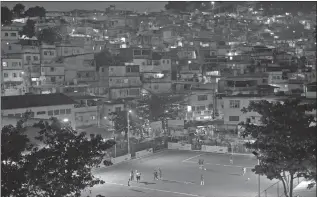  ?? SILVIA IZQUIERDO/AP ?? Residents of the Morro da Mineira favela play in the newly installed soccer pitch powered by player’s footsteps, in Rio de Janeiro.