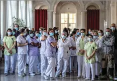  ?? MARTIN BUREAU/POOL PHOTO VIA AP ?? Medical personnel of a nursing home awaiting French Health Minister Olivier Veran in Clamart, south of Paris, Friday. Virus pressure is mounting at French nursing homes, where more than 400 people with the virus have died in the past week. Some residents are again being confined to their rooms and cut off from their families.