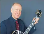  ?? PETER DEJONG/ASSOCIATED PRESS ?? Henry Juszkiewic­z, CEO of Gibson Brands, poses with a Gibson Custom L-5 guitar during the official opening of a European hub in Amsterdam, the Netherland­s, in June 2016.