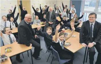  ?? ?? Mark Edwards, editor of the Peterborou­gh Telegraph, left, David Farrelly, govenor at Leighton School and Andrew Bacon, of British Gas, are pictured with pupils of Leighton Primary school.