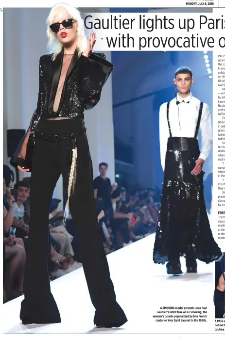  ??  ?? A SMOKING model presents Jean Paul Gaultier’s latest take on Le Smoking, the women’s tuxedo popularize­d by late French couturier Yves Saint Laurent in the 1960s. A PAIR of male and female models walking in step and showcasing their breasts behind...