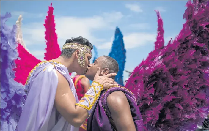  ??  ?? FIGHTING STIGMA: Two men kiss during the Gay Pride Parade at Copacabana beach in Rio de Janeiro, Brazil. The event campaigns for more justice and an inclusive society.