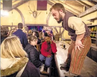  ??  ?? BARTENDER Suds McBride chats with guests at the Crooked Lantern, a lively Evermore tavern.