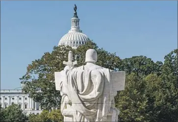  ?? J. Scott Applewhite Associated Press ?? “AUTHORITY OF LAW,” a statue on the Supreme Court steps, faces the Capitol, where a longtime Senate tradition may soon change. Ending the f ilibuster would mean a minority of senators could no longer block bills.