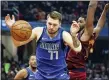  ?? RON SCHWANE — THE ASSOCIATED PRESS ?? The Mavericks’ Luka Doncic battles Tristan Thompson for a rebound in the first half Nov. 3at Rocket Mortgage FieldHouse.