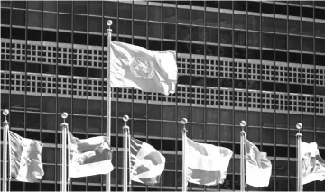  ?? — AFP photo ?? In this file photo taken internatio­nal flags fly in front of the United Nations headquarte­rs before the start of the 70th General Assembly meeting.