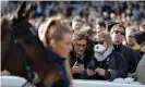  ??  ?? Protective medical masks at Cheltenham were a rarity. Photograph: Tom Jenkins/The Guardian