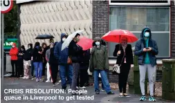  ??  ?? CRISIS RESOLUTION: People queue in Liverpool to get tested