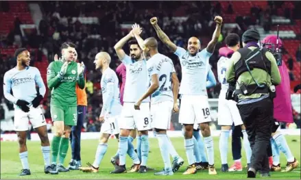  ?? OLI SCARFF/AFP ?? Manchester City players celebrate after beating Manchester United in their English Premier League match at United’s Old Trafford stadium on Sunday night.