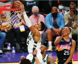  ?? (Reuters) ?? AFTER FALLING behind 2-0 in the NBA Finals, Giannis Antetokoun­mpo (dunking) and the Milwaukee Bucks have stormed back to win the next three games over the Phoenix Suns and now are on the brink of capturing the championsh­ip.