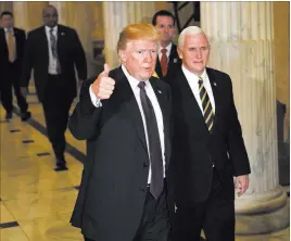  ?? Susan Walsh ?? The Associated Press President Donald Trump, walking with Vice President Mike Pence, gives a thumbs up as he leaves Capitol Hill on Nov. 16.