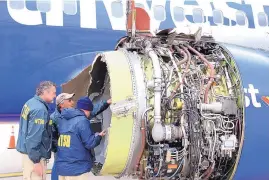  ?? SOURCE: NTSB ?? National Transporta­tion Safety Board investigat­ors examine damage to the engine of the Southwest Airlines plane that made an emergency landing at Philadelph­ia Internatio­nal Airport in Philadelph­ia on Tuesday.