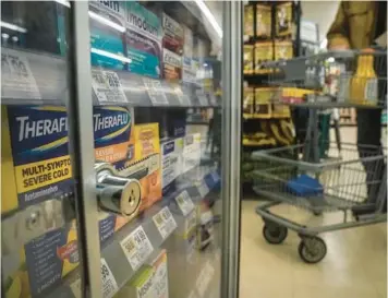  ?? BEBETO MATTHEWS/AP ?? Pharmaceut­ical items are kept locked in a glass cabinet Jan. 31 at a Gristedes supermarke­t in New York. More often, retailers are locking up products or increasing the number of security guards at their stores to curtail theft.