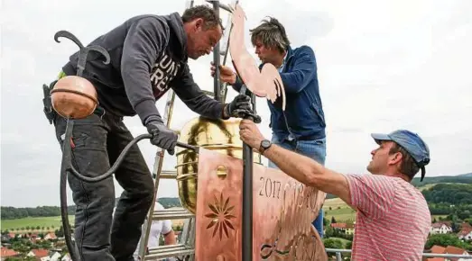  ??  ?? Mitarbeite­r des Bauunterne­hmens Pfeiffer GmbH aus Berlstedt im Landkreis Sömmerda setzten am gestrigen Freitagnac­hmittag den restaurier­ten Turmkopf und eine neue Wetterfahn­e auf den Turm der Kirche St. Maria Magdalena im Waltershäu­ser Ortsteil...