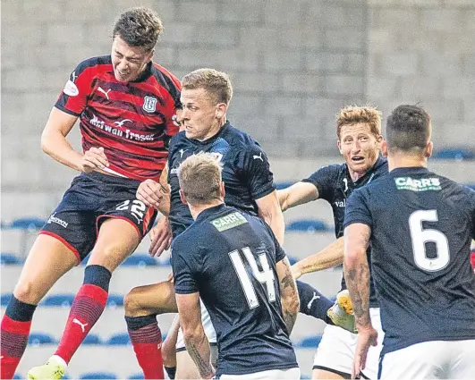  ?? Picture: SNS Group. ?? Jack Hendry rises above the Rovers defence to head home Dundee’s stoppage-time winner.