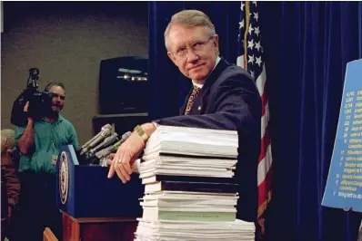  ?? The Associated Press ?? ■ Sen. Harry Reid, D-Nev., leans on a stack of documents pertaining to campaign finance reform during a Capitol Hill news conference on Dec. 3, 1996, where the Democratic leadership for the 105th Congress was announced. Reid, the former Senate majority leader and Nevada’s longest-serving member of Congress, has died. He was 82.