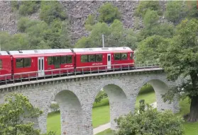  ??  ?? OUR FAVORITE TRAIN FEATURE was the Brusio Spiral Viaduct, a single-track arched stone spiral railway viaduct, where the train traveled over, around and beneath its own pathway shaped like a coiled serpent.