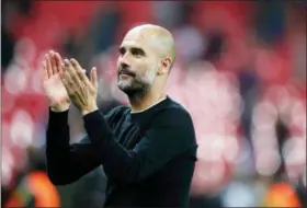  ?? FRANK AUGSTEIN — THE ASSOCIATED PRESS FILE ?? In this file photo dated Saturday Manchester City manager Pep Guardiola applauds the fans as he walks from the pitch after the end of the English Premier League soccer match against Tottenham Hotspur at Wembley stadium in London. The World Cup triumphs...