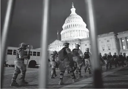  ?? JACQUELYN MARTIN/ASSOCIATED PRESS ?? Members of the National Guard arrive to secure the area outside the U.S. Capitol on Wednesday.