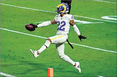  ?? RICK SCUTERI / AP ?? Rams cornerback Troy Hill (22) runs in an intercepti­on for a touchdown against the Cardinals during the second half of Sunday’s game in Glendale, Ariz.