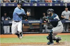  ?? —AP ?? Tampa Bay Rays’ Johnny Field is about to get tagged out at the plate by Seattle Mariners catcher Mike Zunino for the final out in the ninth inning and secure a 5-4 Seattle victory in MLB action Sunday in St. Petersburg, Fla.