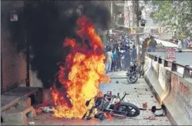  ?? SAKIB ALI/HT ?? A police motorbike burns in Ghaziabad during protests by Dalit groups on Monday.