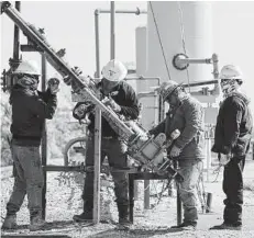  ?? Kin Man Hui / Staff file photo ?? A crew installs a flame arrestor for Recoil Resources near Poth in 2020. The industry will need to certify it is producing responsibl­y.