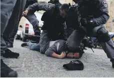  ?? Reuters ?? Israeli police arrest a Palestinia­n protester outside Haram Al Sharif on Tuesday after scuffles broke out