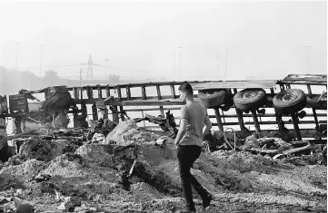  ?? — Reuters photo ?? A man inspects the site of a suicide truck bomb at a checkpoint in the south of the Iraqi capital Baghdad, Iraq.