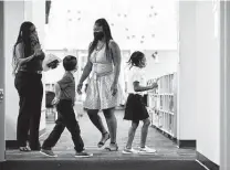  ?? Godofredo A. Vásquez / Staff photograph­er ?? Students make their way to their classroom during the first day of school at Heflin Elementary in Alief ISD last week. Pediatrici­ans recommend in-person learning with precaution­s including masks.