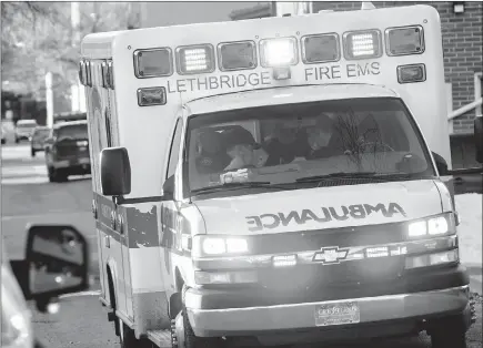  ?? Herald file photo by Ian Martens ?? An ambulance crew works at a call downtown, as the City fought to retain local integrated EMS Dispatch in Lethbridge. @IMartensHe­rald