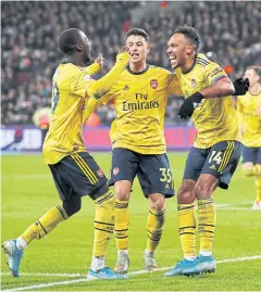  ?? REUTERS ?? Arsenal’s Pierre-Emerick Aubameyang, right, celebrates scoring against West Ham with Nicolas Pepe, left, and Gabriel Martinelli.