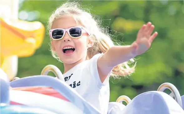  ??  ?? Five-year-old Grace McMurray enjoys a funfair held at Dundee Flower and Food Festival, which attracted thousands of visitors to Camperdown Park.