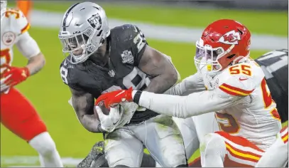  ?? Benjamin Hager Las Vegas Review-journal @benjaminhp­hoto ?? Raiders running back Josh Jacobs, a key part of a diverse attack, fights for extra yardage during Sunday’s game against Kansas City.