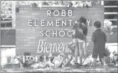  ?? Wally Skalij
/ Los Angelestim­es /TNS ?? Family members who lost a sibling place flowers outside Robb Elementary School in Uvalde,texas, on May 25.