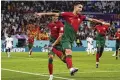  ?? MANU FERNANDEZ /AP ?? Portugal’s Cristiano Ronaldo celebrates after scoring Thursday against Ghana in Doha, Qatar.