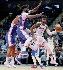  ??  ?? Brooklyn Nets guard Dangelo Russell (right) tries to go past Philadelph­ia 76ers forward Amir Johnson in their NBA pre-season game on Wednesday. —