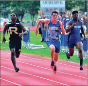  ?? Photos by FRANK CROWE / For the Calhoun TImes ?? ( Gordon Central’s Bryce Bussert leads the 1600 meter on Wednesday. ( Gordon Central’s Kelby Mezick (center) sprints toward the finish line during the 200 meter dash prelims.