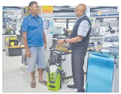  ?? Picture: LOSALINI VUKI ?? Narhari retail sales manager Ashok Kumar, right, assists customer Aliposo Vuki with the Modyl 2470PSI water blaster at Harifam Centre, Grieg St.