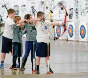  ?? [PHOTO BY NATE BILLINGS, THE OKLAHOMAN] ?? Students compete in the Oklahoma National Archery in the Schools state championsh­ips at State Fair Park in February.