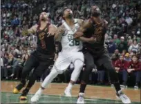  ?? ELISE AMENDOLA — ASSOCIATED PRESS ?? George Hill, left, and Jeff Green, right, fight for position with Celtics guard Marcus Smart during the second half May 27 in Boston.