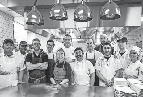  ?? PROVIDED BY ROCHE PHOTO ?? Oak and Reel’s 2023 Culinary Collective welcomed students enrolled in culinary programs at Oakland Community College and Henry Ford College to cook alongside Michelin-starred chef Michael White (back center) as well as Oak and Reel's team of chefs.