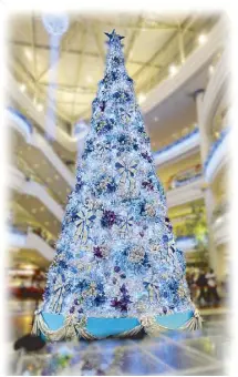  ??  ?? Christmas tree yule love: A towering 35-foot-tall Christmas tree in elegant silver, blue and magenta is a colossal beauty at Robinsons Magnolia.