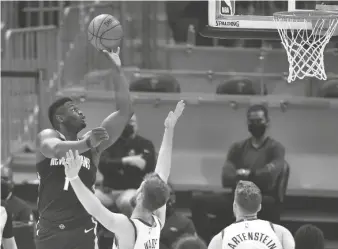  ?? DAVID RICHARD/USA TODAY SPORTS ?? Pelicans forward Zion Williamson (1) shoots the ball over Cavaliers forward Dean Wade on Sunday in Cleveland.