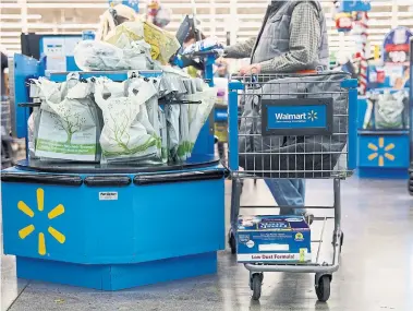  ?? PATRICK T. FALLON BLOOMBERG FILE PHOTO ?? In a letter to suppliers, Walmart Canada said it will charge an “infrastruc­ture developmen­t fee” of 1.25 per cent on the price of products it purchases from suppliers, and another five per cent on the cost of products sold through e-commerce.
