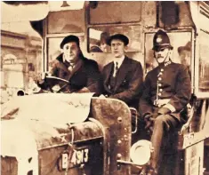  ??  ?? Volunteers drive a bus during the General Strike of 1926, with a policeman to keep order