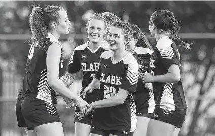  ?? Photos by Kin Man Hui / Staff photograph­er ?? Clark players congratula­te Taylor Tommack after she scored to tie the game at 1 in the first half. Tommack scored three goals.