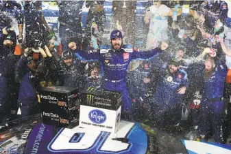  ?? Jared C. Tilton / Getty Images ?? Martin Truex Jr., who led for 464 of the race’s 500 laps, celebrates at Martinsvil­le Speedway. The win gave him a spot in the NASCAR championsh­ip race, to be held in November.