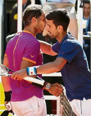  ??  ?? Good job: Novak Djokovic (right) hugs Rafael Nadal after their semi-final match in the Madrid Masters on Saturday. Nadal won 6-2, 6-4. — Reuters