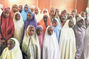  ?? PHILIP OJISUA/AFP/GETTY IMAGES ?? Nigerian schoolgirl­s released by Boko Haram militants wait to meet Nigeria’s president last week in Abuja.